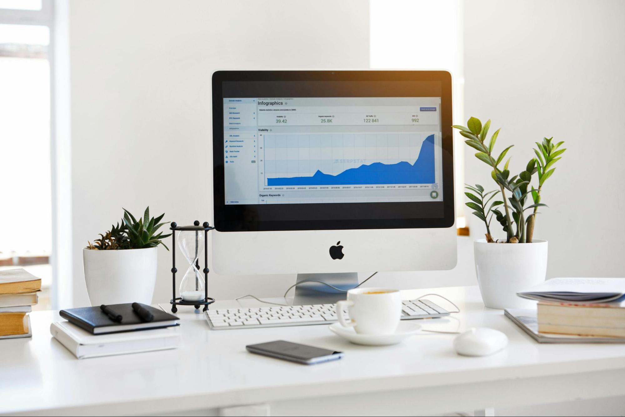 Computer on a desk displaying a line graph